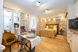 a bedroom with a bed and a table in a room at Kruna apartments est 2024 in Split