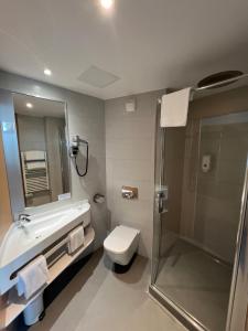 a bathroom with a toilet and a sink and a shower at SoBlue Hôtel in Antibes