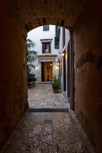 an alley way with an archway in a building at Sundial Lodge in Chania +26 photos