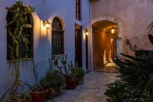 an alley with potted plants in a building at Sundial Lodge in Chania