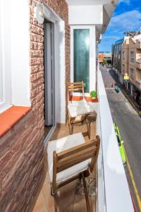 a balcony with two chairs and a table at Calas Beach Corralejo in Corralejo