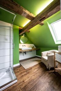 a green bathroom with a sink and a shower at GH Maisonette Studio Whg 45 in Bastorf