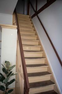 a staircase in a house with wooden railings at GH Maisonette Studio Whg 45 in Bastorf