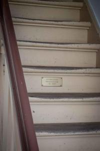 a set of stairs with a sign that says staircaseartifacts at GH Maisonette Studio Whg 45 in Bastorf