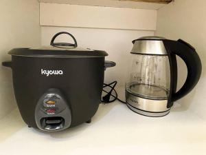 a slow cooker and a blender on a counter at Cozy Studio Unit in Abreeza Place Tower 1 with parking in Davao City