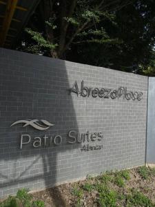 a sign for a side of a stone building at Cozy Studio Unit in Abreeza Place Tower 1 with parking in Davao City