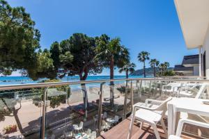 a balcony with a view of the beach and palm trees at Piccolo hotel le Palme in San Bartolomeo al Mare +18 photos