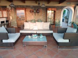 a living room with a couch and chairs and a table at Relais Villa Raffaele by Emilia in Forio d'Ischia