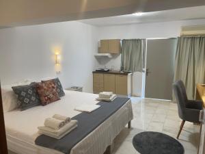 a bedroom with a bed with towels on it at Hotel Kourkoumelata in Argostoli