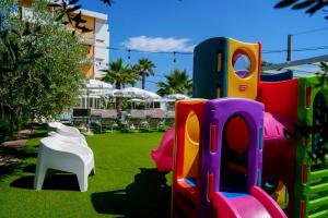 a group of play equipment on the grass at Hotel Belvedere in Martinsicuro