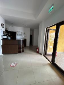 an empty living room with a large glass door at Orient Mamaia Nord in Mamaia Sat/Năvodari