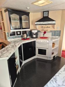 a kitchen with a toy stove and a sink at Vila Giruliai in Klaipėda