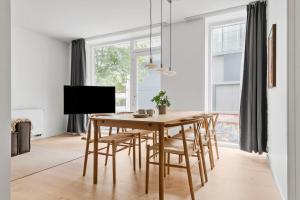 a dining room with a wooden table and chairs at Spacious 2BR Inner City Apartment for 6 People in Aarhus