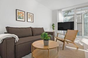 a living room with a couch and a table at Amazing 2BR w Balcony in the Heart of Aarhus City in Aarhus +30 photos