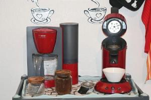 a shelf with a coffee maker and a blender at Gite le GINKGO 50 M2 in Rougegoutte +22 photos