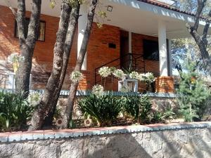 a flower garden in front of a building at Cabaña Camila in Las Palomas