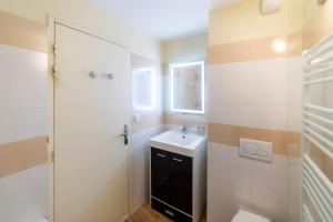 a bathroom with a sink and a toilet and a shower at T2 au cœur du centre historique de Briançon #1 in Briançon