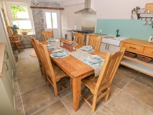 a dining room with a table and chairs in a kitchen at Suffolk House in Narberth