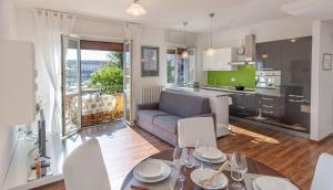 a kitchen and living room with a table and chairs at Rosalba in Verbania