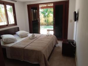 Ένα ή περισσότερα κρεβάτια σε δωμάτιο στο Pipa Beleza - Hospedagem Econômica