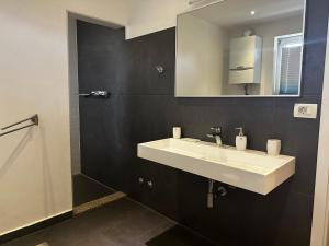 a bathroom with a white sink and a mirror at Deluxe apartment Playa in Valbandon +73 photos