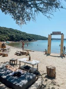 a beach with a table and chairs on the sand at Deluxe apartment Playa in Valbandon