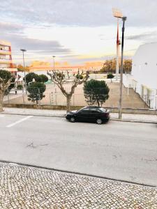 a black car parked on the side of a street at Cantinho do Liceu in Figueira da Foz