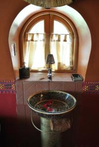 a bathroom with a sink and a window at ALLKAMARI Eco-Resort&Spa in Uni