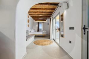 a hallway with white walls and a wooden ceiling at iLocal Project accommodation&sofer services in Zefiría