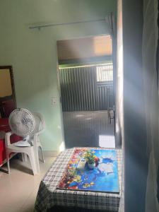 a room with a bed and a chair and a door at Quarto privativo,não é compartilhado! in Parauapebas
