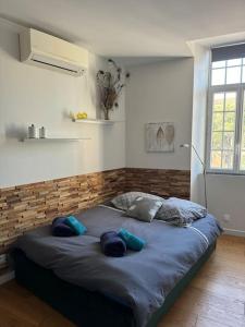 a bed in a room with blue pillows on it at 5 - Cosy Studio in Old Antibes in Antibes