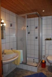 a bathroom with a shower and a sink at Schönes Ferienhaus in Althagen mit Terrasse und Grill in Ahrenshoop +7 photos
