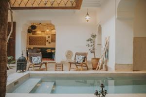a living room with a pool in the middle at Riad Djebel in Marrakech