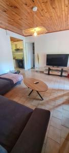 a living room with a couch and a coffee table at Maison du Peyrou in Pradons