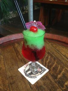 a drink with a cherry on top on a table at Global Backpackers Port Douglas in Port Douglas