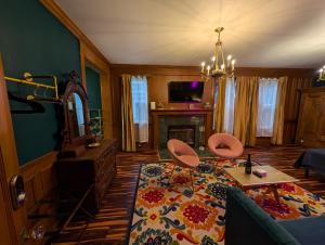 a living room with a couch and a fireplace at The Queen Hotel- Downtown Luxury in Sturgeon Bay