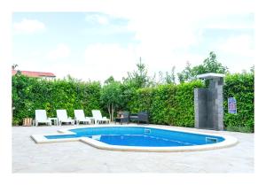 a swimming pool with lounge chairs and aitating at Istrian Azure in Pula