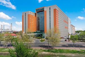two tall buildings in a city with trees at CENTRAL CHIC APARTAMENT with SPA and GYM in Bucharest