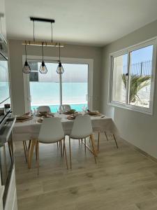 a dining room with a table and chairs and the ocean at Casa Mer in Tías