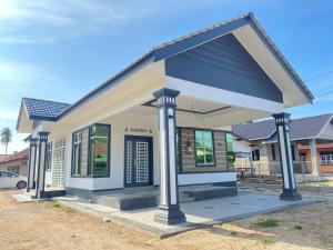 a small house with a blue roof at Kak Hae Homestay in Tumpat