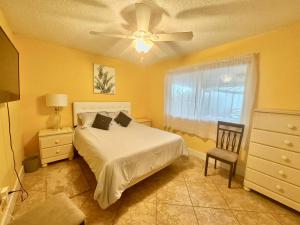 a bedroom with a bed and a ceiling fan at Fun In The Sun: Canal Access in Cape Coral +62 photos