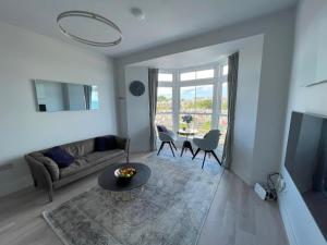a living room with a couch and a table at Henrys in St Ives