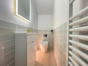 a bathroom with a toilet and a sink at Henrys in St Ives +33 photos