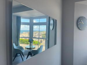a room with a table and chairs and a window at Henrys in St Ives