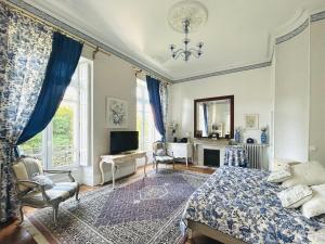 a bedroom with a bed and a tv in it at Château Mesdames in Labastide-Rouairoux