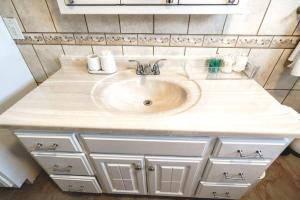 a bathroom sink with a white counter top at Tufts 4BDR-15-MIN to Harvard&Boston-Free Parking in Somerville