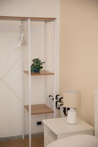 a white room with a white desk with a lamp at Green rooms in Bari +63 photos