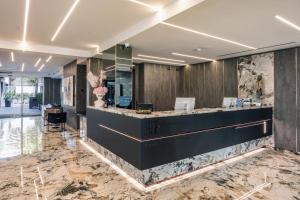 a lobby with a reception desk and marble floors at Hotel & Resort Tre Fontane Luxury in Portici