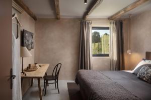 Un dormitorio con una cama y un escritorio y una ventana. en Villa Bagnoli, en Boljun 60 fotos más