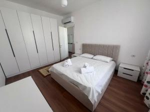 a bedroom with a bed with two towels on it at Pegasus luxury 1 in Tirana